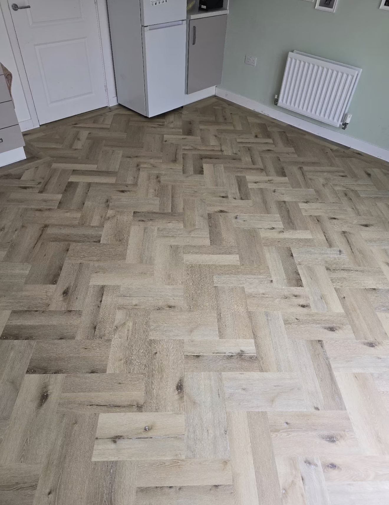 Close detail of oak herringbone blocks showing grain and colour variation