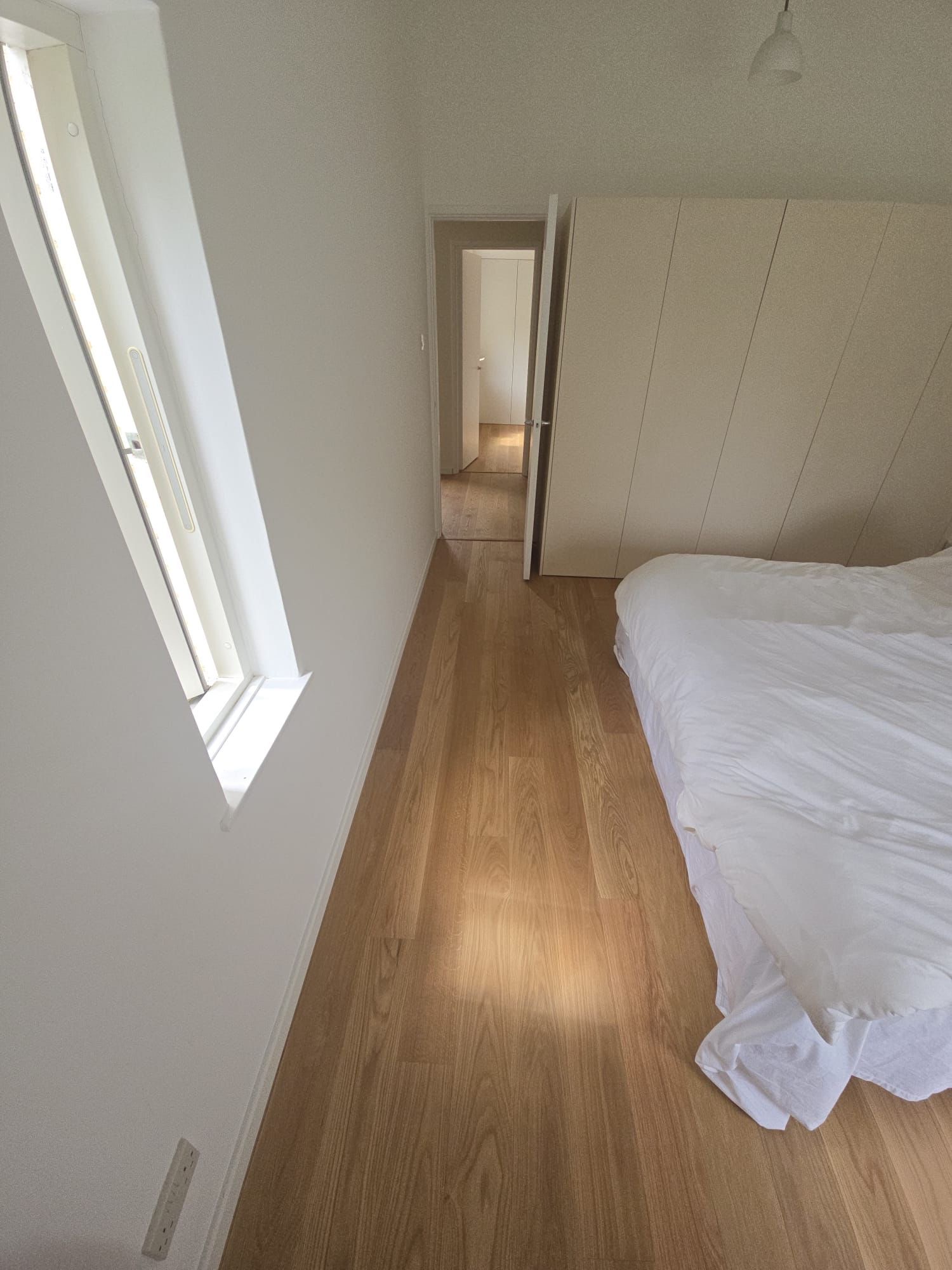 Sunlit oak boards in a bedroom