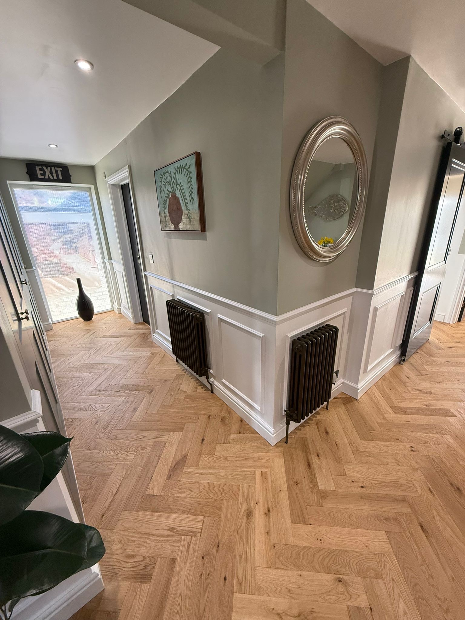 Oak herringbone through a panelled hall