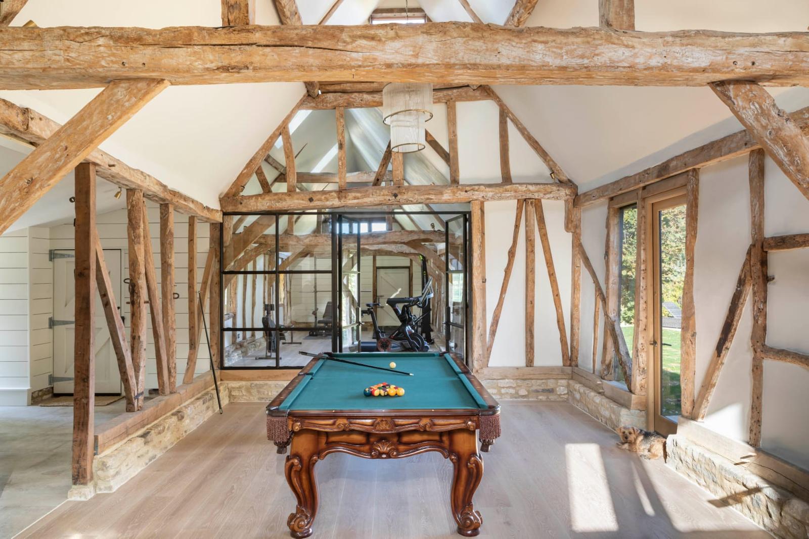 Pale oak floor running through a restored timber-framed residence